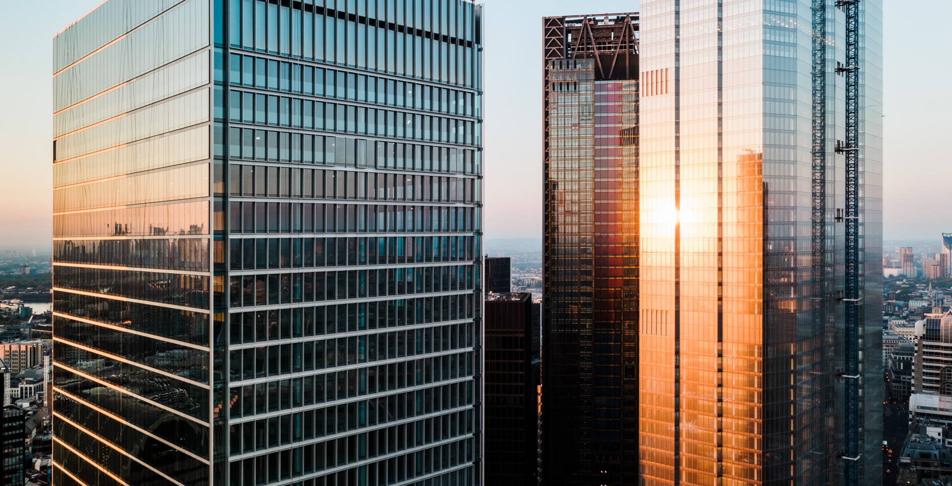 Business and finance concept, looking up at high rise office building architecture at night in the financial district of a modern metropolis. | © © 2021 R.M. Nunes
