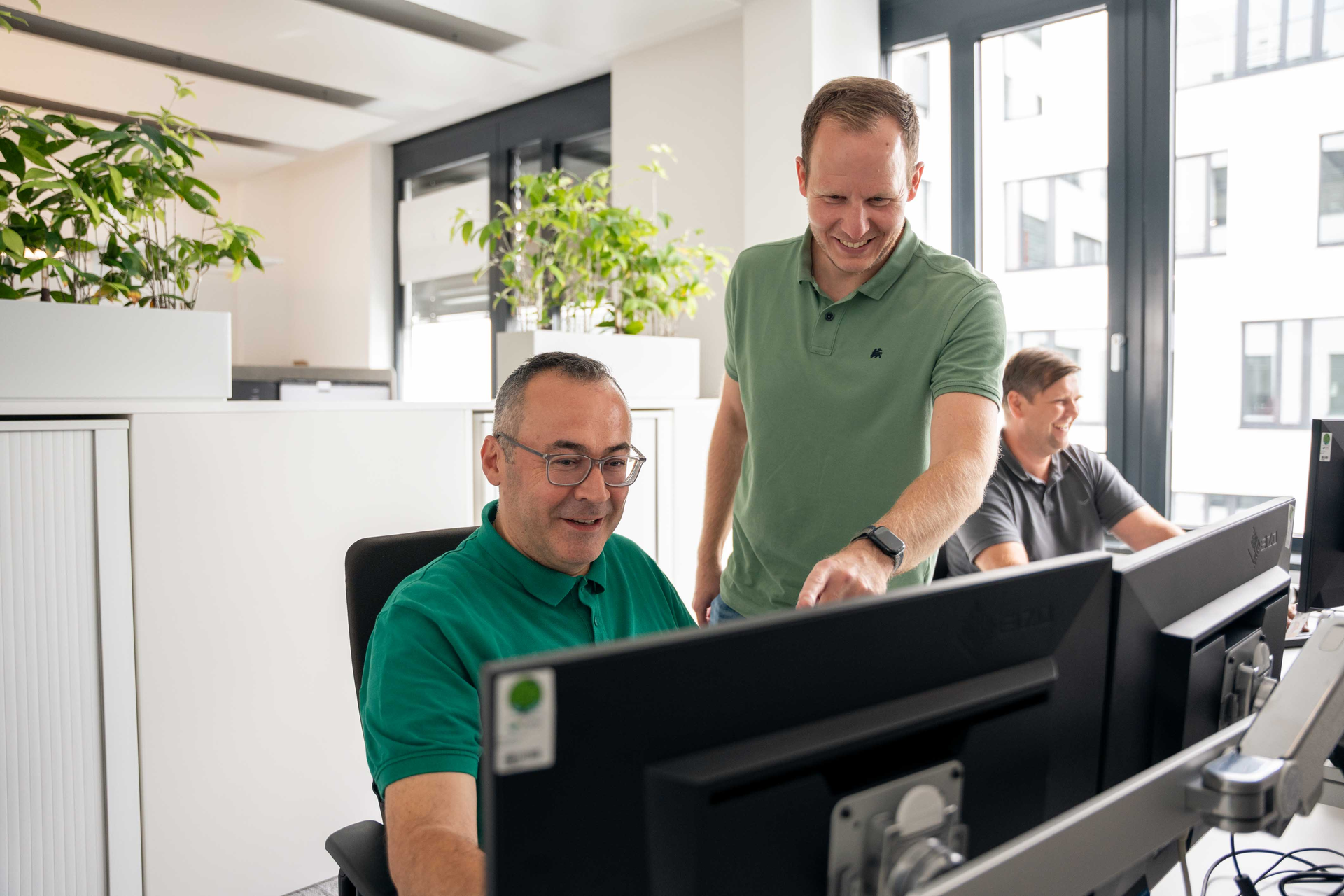 Sopra employees working together on a desktop computer
